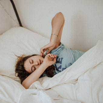 Woman laying in bed in pain